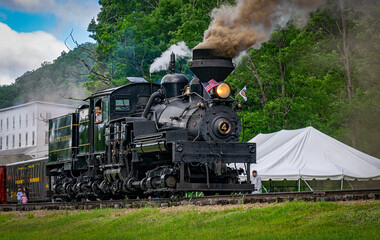 Cass, West Virginia, June 18, 2022 - A View of an Antique Shay Steam Engine Warming Up, Blowing Smoke and Steam on a Sunny Day