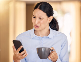 Annoyed, confused and stressed woman on phone reading an article on an online website. Disgusted business lady browsing on social media or the internet with smartphone at office with cup of coffee.