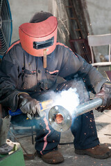 Workers for welding pipes in the factory