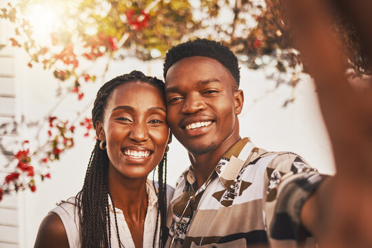Selfie of happy black woman and man, couple in love on outdoor sunset date. Beautiful young girlfriend and boyfriend smile, photographs portrait memory together and share relationship online internet