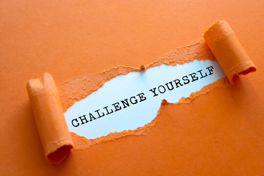 CHALLENGE YOURSELF message written under torn paper.