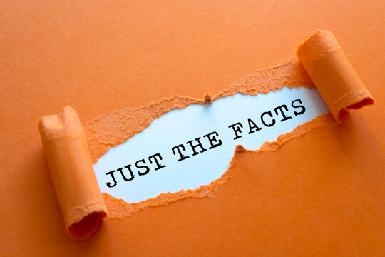 Torn white paper revealing the words Just the facts