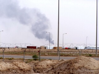 Smoke from an air station in Basra, Iraq, during Operation Iraqi Freedom