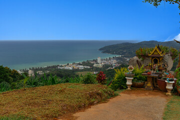 Karon Beach in Phuket Thailand, turquoise blue waters, lush green mountains colourful skies. Phuket is a tropical island many palms