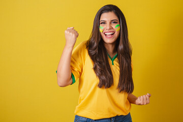 Woman supporter of Brazil, world cup 2022, soccer championship, celebrating for victory, happy and...