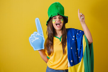 Woman supporter of Brazil, world cup 2022, dancing with foam finger.