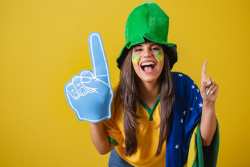 Woman supporter of Brazil, world cup 2022, dancing with foam finger.