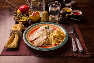 Fried chicken filet with french fries and rice peruvian gourmet restaurant comfort food