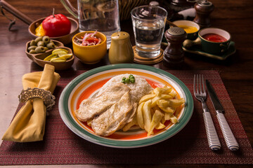 Fried chicken filet with french fries and rice peruvian gourmet restaurant comfort food