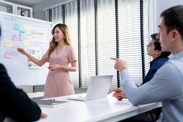 Competent office workers from various nationalities are debating, discussing and brainstorming in...