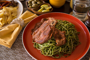 Green sauce pesto spaghetti with pork chop peruvian gourmet comfort food