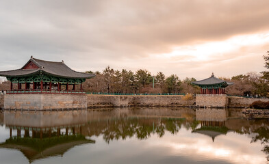 Fototapeta premium Traditional Korean pagoda temple reflection at Wonji Pond in Gyeonju South Korea during sunset