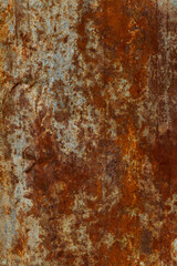 Rust on the galvanized sheet metal used as a fence outside the building.