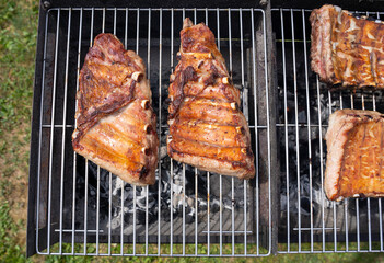 Roasted Juicy spare ribs cooked over the coals on a barbecue. Summer and holiday time. Delicious food