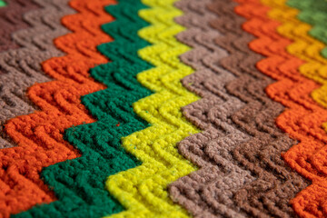 Fototapeta premium close-up of grandma's retro zigzag striped blanket, crocheted or knitted, grandma's house, cozy and warm