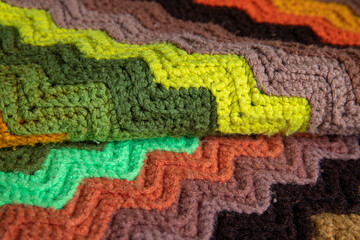 Fototapeta na wymiar close-up of grandma's retro zigzag striped blanket, crocheted or knitted, grandma's house, cozy and warm