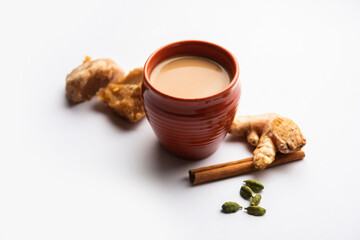 Obraz na płótnie Canvas Jaggery tea or Gur ki chai with ingredients like gud, ginger or adrak, green cardamom and cinnamon