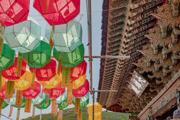 Naklejka premium Colorful lanterns and traditional architecture at the Beomeosa Buddhist temple in Busan South Korea during Buddha's birthday festival