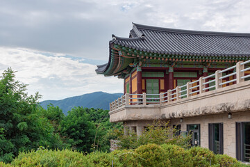 Traditional Korean architecture and lush green forest and mountains at Buseoksa Buddhist temple in South Korea on a cloudy day