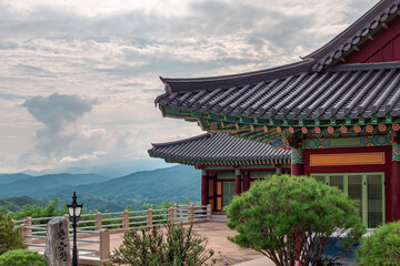 Traditional Korean architecture and lush green forest and mountains at Buseoksa Buddhist temple in South Korea on a cloudy day