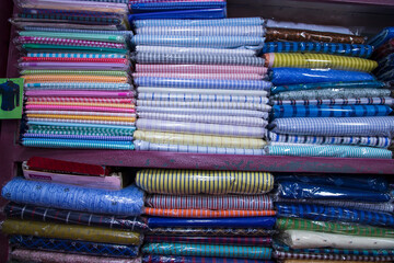 Patterned Textile Fabrics  stacked on a retail Shop Shelf for sale