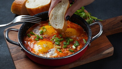 Shakshouka, eggs poached in sauce of tomatoes, olive oil, peppers, onion and garlic, Mediterranean cuisine