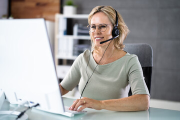 Business Service Agent With Headset At Computer