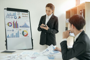 Asian businesswoman planning work in conference room with team
