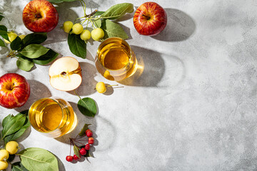  Ripe red apples and small green apples and apple juice on a light gray background, apple harvest background, copy space for text