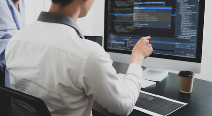 Obraz premium Team of programmers working with computer programming, professional development, and coding technology, working on high-quality visual software development websites