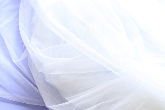 white tulle cloth on purple paper background