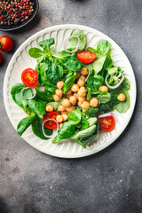 vegetable salad chickpea, legume, lettuce, mache, tomato fresh healthy meal food snack diet on the table copy space food background 
