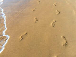 footprints in the sand of La Barrosa beach in Cadiz, Spain