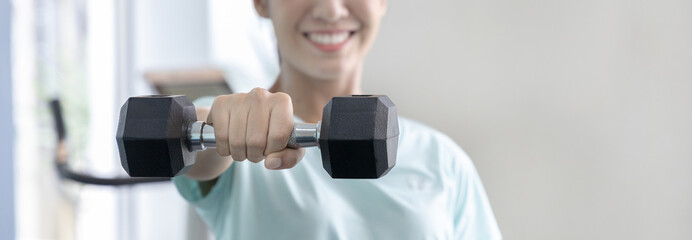 Beautiful and shapely Asian woman working out in the gym, Play exercise machine treadmill,...