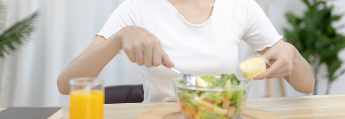 Asian woman making vegetable salad in her home kitchen, Vegetables contain a wide variety of vitamins and minerals, High-fiber and low-calorie diets, Healthy vegetable salad idea, Appetizer concept.