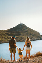 Family walking together parents with child outdoor active summer vacations lighthouse view healthy...