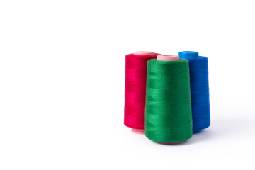 Three skeins of colored thread for sewing. Pink, blue and green spool of thread. Manufacture of wearing apparel. Copy cpase