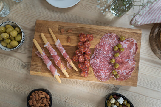 Sharing platter board with a selection of cured meats and snacks. Flat lay style picnic food photo