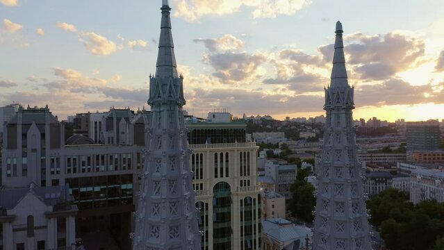 Big city urban cityscape with evening sunset sky. Decorative Roman Catholic Church of St. Nicholas.