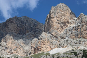 Val Badia, Italy-July 18, 2022: The italian Dolomites behind the small village of Corvara in summer days with beaitiful blue sky in the background. Green nature in the middle of the rocks.