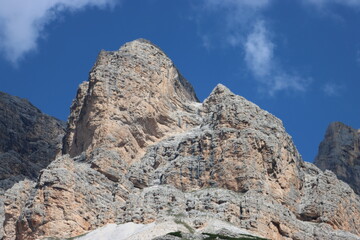 Val Badia, Italy-July 18, 2022: The italian Dolomites behind the small village of Corvara in summer days with beaitiful blue sky in the background. Green nature in the middle of the rocks.