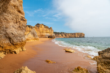 Holidays in the Algarve in summer on the beach at Praia da Coelha, Albufeira. Portugal