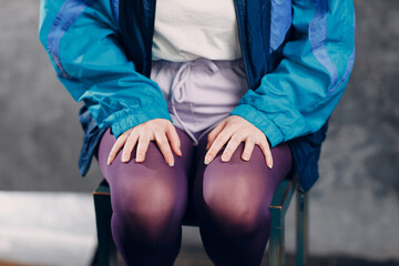 Young sporty woman 80 and 90's style. 90s fashion legs knees tights close up girl