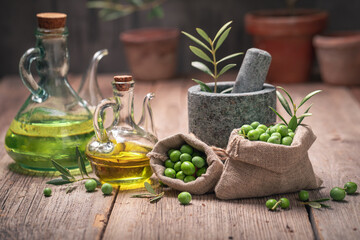 Small raw olives with branch and olive berries.