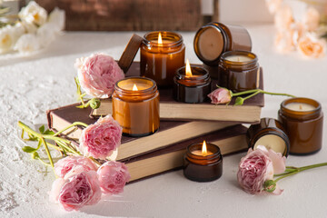 A set of different aroma candles in brown glass jars. Scented handmade candle. Soy candles are burning in a jar. Aromatherapy and relax in spa and home. Fire in brown jar.
