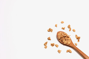 delicious granola with oat on wooden spoon on grey white background. Dietary food for healthy meal. Cereal for breakfast.