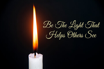 Inspirational quote text - Be the light that helps others see. With candle on dark background