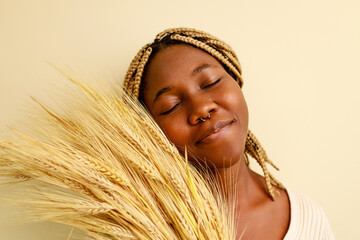African american woman with braids and wheat plants
