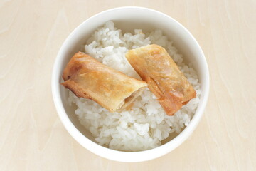 Chinese food, spring roll halved cut on rice 