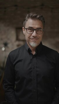 Middle age confident businessman in business casual. Entrepreneur in black shirt. Portrait of mid adult, mature age man, happy smiling.